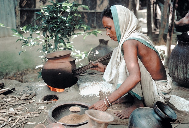 A lady pictured making food in Bangladesh