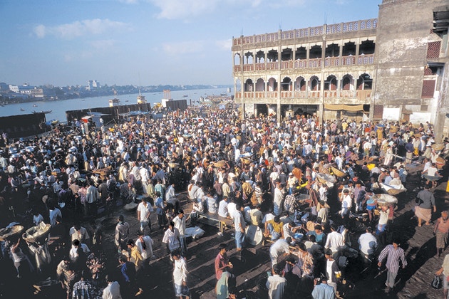 A crowd of people at a market in Dhaka